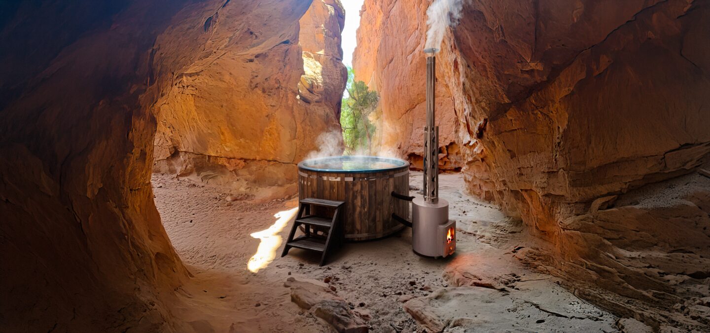 Wooden hot tub DIANA by Makoya Spa stands in a narrow canyon with red rock walls in a natural setting. 