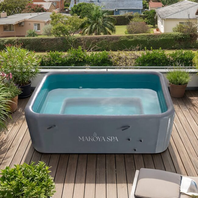 Modern Makoya Spa Hot Tub Pool on a stylish wooden terrace, nestled in a green garden landscape.